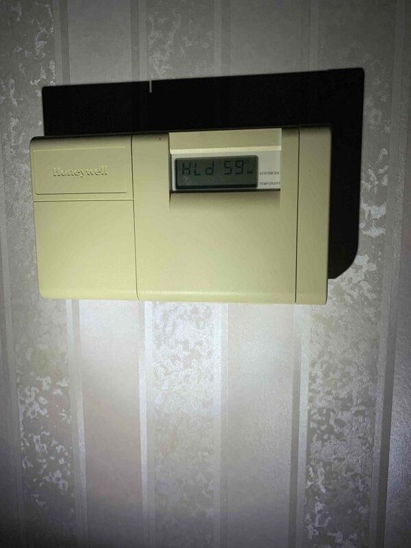 Perry, OH - Responded to no heat call for aging gas furnace system. Diagnostic testing revealed thermostat malfunction with display showing "ALD" error code and reading 59°F despite heat call. Replaced faulty Honeywell thermostat, calibrated new unit, and verified proper system operation through complete heating cycle test.