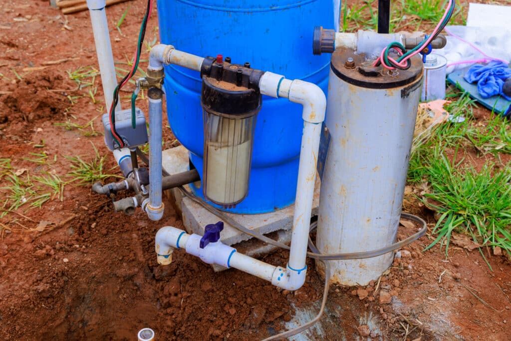 blue well pump in red clay