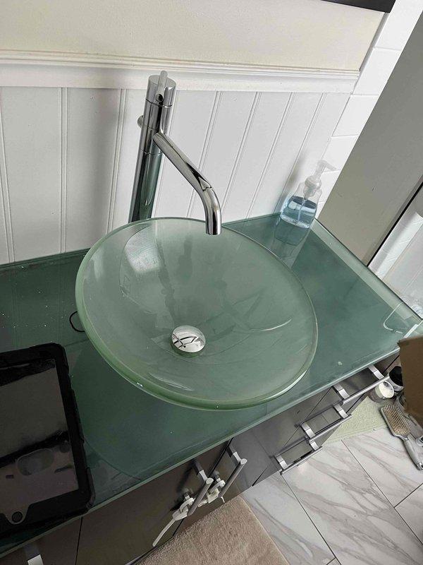 Pepper Pike, OH - Installed new chrome single-post lavatory faucet on customer's modern glass vessel sink. Material was on shelf as specified in work order. Completed installation with proper connections and verified proper operation before departure.