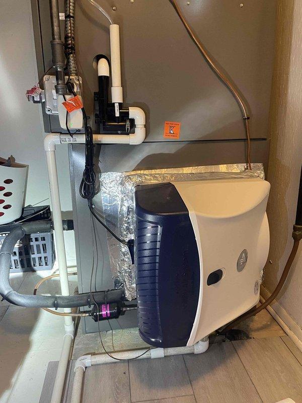 Responded to customer report of water leak in HVAC room where customer had proactively shut off humidifier. Inspection revealed condensate line issue at the connection point with visible water damage on floor. Sealed joint with appropriate compound and verified proper drainage function to resolve the leak.
