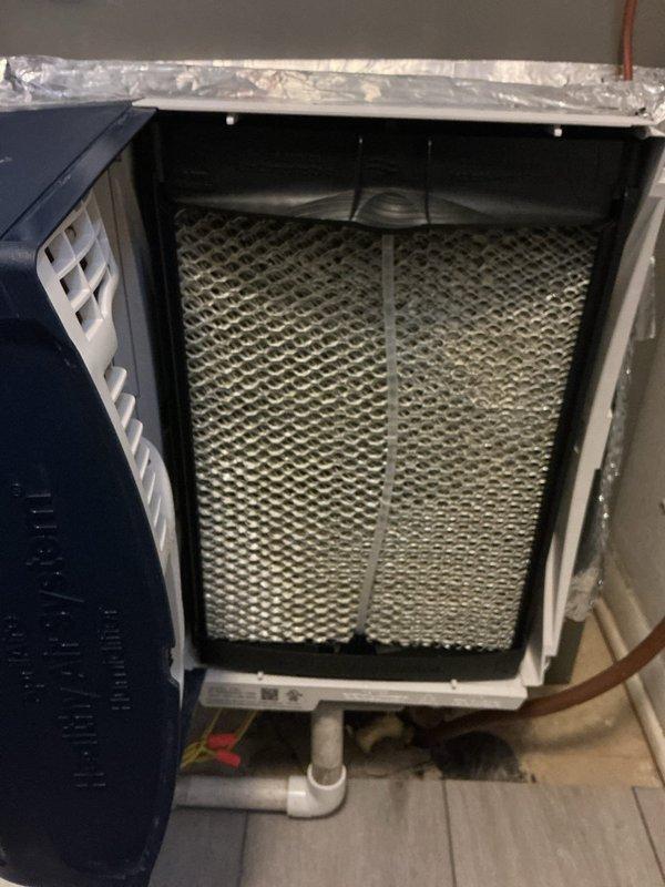 Completed follow-up service call to replace the hydro water panel in customer's humidifier system. Removed old humidifier panel which showed significant mineral deposits and discoloration throughout the honeycomb structure. Installed new water panel to restore proper humidification function and ensure optimal system performance.