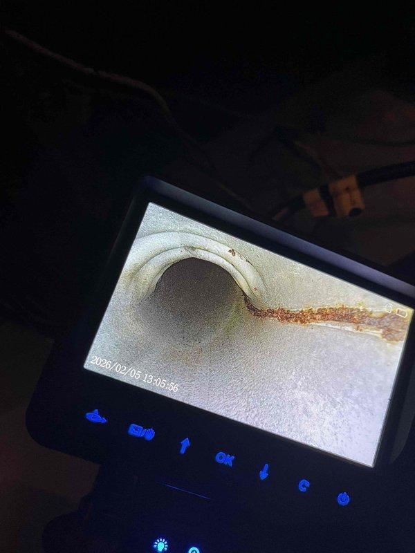 Conducted diagnostic inspection of HVAC system using borescope camera to examine interior condition of heat exchanger tubes. Visual inspection revealed signs of corrosion along edge of heat exchanger. Inspected electrical connections and wiring harness (red, blue, white, and yellow wires) to verify proper installation and identify potential issues contributing to furnace malfunction.