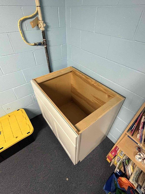Performed rough-in plumbing installation for a temporary kitchen sink in the basement to be used during main kitchen renovation. Installed necessary copper and PVC piping connections to existing plumbing system. Positioned utility cabinet in corner location with appropriate access to water supply and drainage.