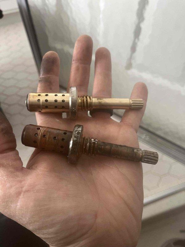 Returned to install Symmons shower cartridge previously sold to customer. Removed corroded brass cartridge and replaced with new component after shutoff valve was secured. Verified proper operation of shower fixture following installation.