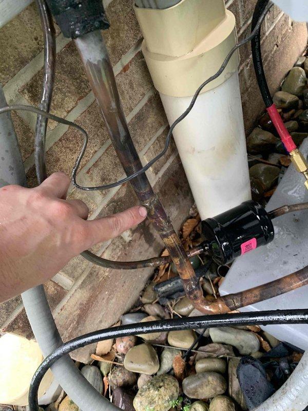Performed nitrogen leak check on HVAC system after customer reported banging noise from AprilAir air handler. Inspected system components and documented conditions of water filtration system and associated plumbing showing significant sediment accumulation and copper pipe corrosion requiring attention.
