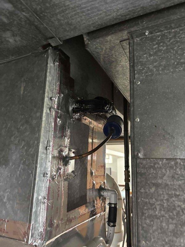 Conducted estimate for relocating air handler from rear of residence to side location per customer request. Assessed existing ductwork system including galvanized metal supply and return ducts, evaluated current mechanical room configuration with Rheem furnace and water heater, and documented existing conditions to determine scope of work for repositioning equipment and modifying duct runs accordingly.