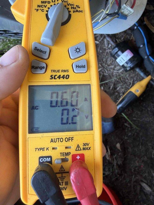 Completed cooling system tune-up and diagnostic evaluation. Performed electrical measurements using clamp meter, recording amperage draw of 60 amps at 0.2 volts, and verified system temperature readings at 39.56°F, indicating proper refrigerant performance and operational efficiency.