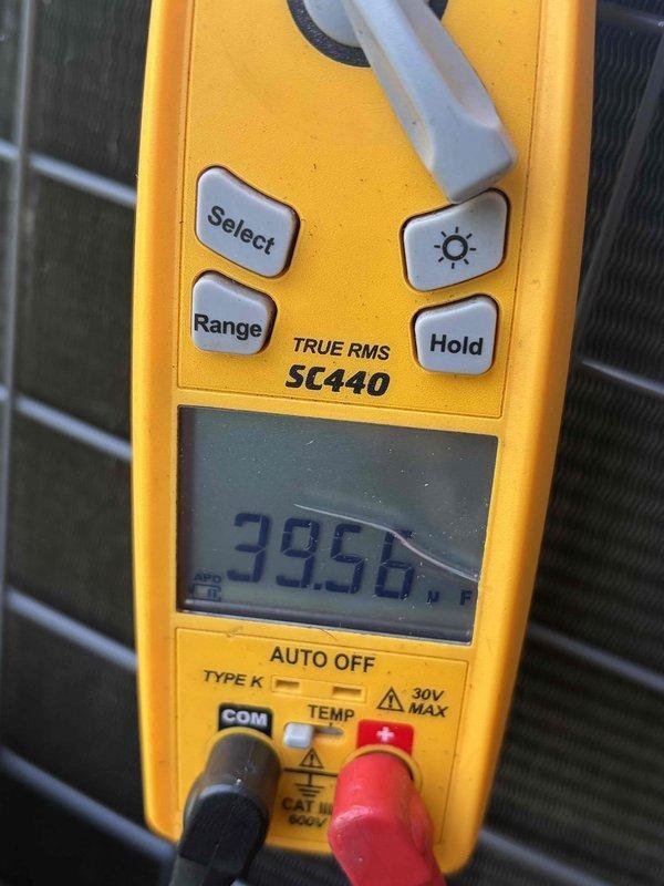 Completed cooling system tune-up and diagnostic evaluation. Performed electrical measurements using clamp meter, recording amperage draw of 60 amps at 0.2 volts, and verified system temperature readings at 39.56°F, indicating proper refrigerant performance and operational efficiency.