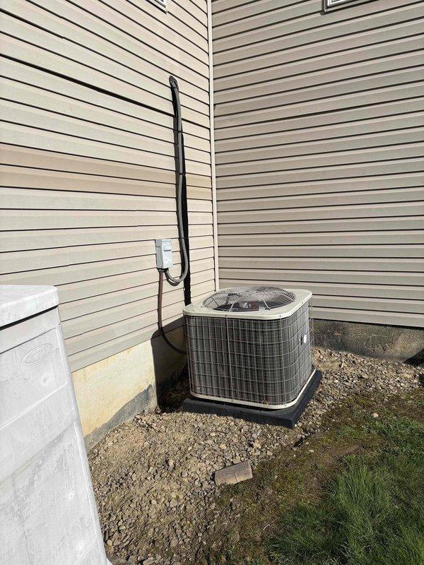 Responded to AC replacement inquiry for system experiencing refrigerant loss. Assessed existing split-system air conditioning unit and indoor evaporator coil. Documented current equipment configuration including outdoor condenser unit positioned on gravel pad with proper electrical disconnect and indoor ceiling-mounted air handler. Provided estimate for complete HVAC system replacement to address refrigerant deficiency and aging equipment.