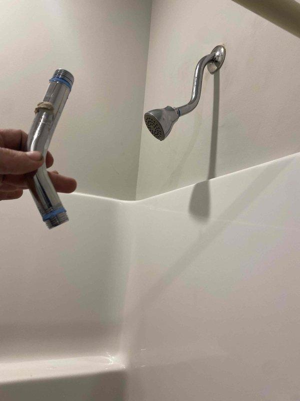 Completed installation of Chrome Moen Magnetix handheld showerhead system as a return service call. The new fixture was mounted to the existing shower arm with proper sealing, featuring a chrome finish spray head connected via flexible metal hose to a wall-mounted holder with oil-rubbed bronze finish. System was tested for proper water flow and functionality, with no leaks detected at connection points.