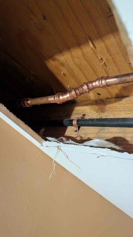 Returned to property for follow-up on outdoor hose bib replacement project originally estimated in October. Accessed ceiling cavity to evaluate existing plumbing configuration and install new gate valve as specified in previous site assessment. Removed two severely corroded outdoor hose bibs exhibiting significant rust, mineral buildup, and deteriorated valve bodies. Opened ceiling access point to expose copper supply lines and install shutoff valve for improved system control. Replaced both exterior hose bibs with new frost-free sillcocks, ensuring proper pitch for drainage and secure mounting to exterior siding. Restored ceiling access point upon completion of valve installation.